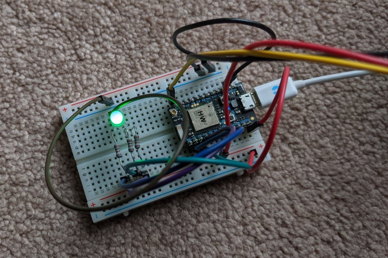 Close-up of the breadboard showing the Particle Photon, resistors, and lit RGB LED